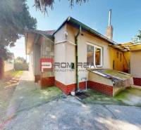 Family house on Hurbanova Street in Ivanka pri Dunaji with a concrete yard and trees.