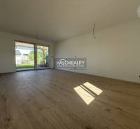 A spacious living room with wooden flooring in a family house.