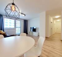 Living room with dining area and geometric lamp in a 3-room apartment.