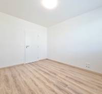 A room with a light floor and white walls in a 3-room apartment.