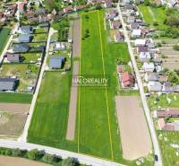 Aerial view of residential plots in Udiča, surrounded by houses and greenery.