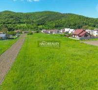 Plots - housing in Udiča with green meadows and rural houses near the forest.