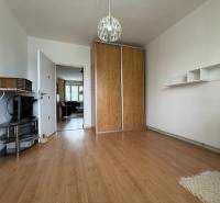 Interior of a 2-room apartment with wooden flooring, built-in wardrobe, and TV stand.