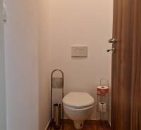 Bathroom with toilet and toilet paper holders in a studio apartment.