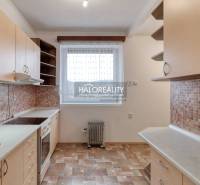 A kitchen in a 3-room apartment with a window, a countertop, and ceramic tiles.