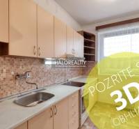 The kitchen of a 3-room apartment with light furniture and mosaic tiles.