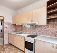 A kitchen in a 3-room apartment with a kitchen unit, a hob, and storage space.