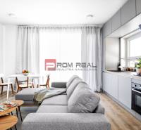 A bright space in a 3-room apartment with a kitchen unit and a dining area.