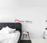 Bedroom with a bed and a bookshelf in a 3-room apartment.