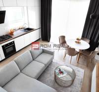 A bright kitchen connected to the living room, a dining nook, and stylish armchairs in a 3-room apartment.