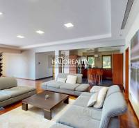 A spacious living room with a comfortable sofa set and a dining table in a family house.