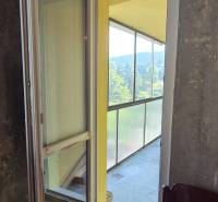 A glazed balcony with a sofa in a 3-room apartment.