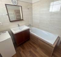 Bathroom in a 3-room apartment with a bathtub, sink, and washing machine.