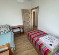A room with two beds and a table in a 3-room apartment.