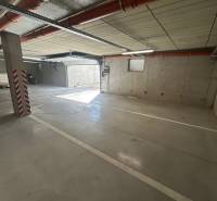 Parking space in the underground garage of a 3-room apartment, with an access ramp.