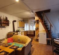 Interior part of the cottage, kitchen, furniture, stairs, simple furnishings.