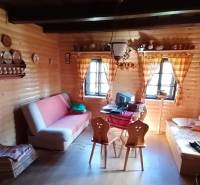 Interior of a family house with wooden paneling, a sofa, and traditional furniture.
