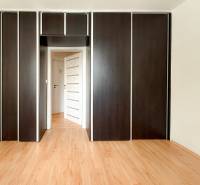 In the 3-room apartment, you can see a built-in wardrobe with dark doors and a wooden floor.