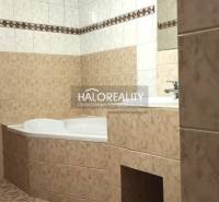 Bathroom in a 4-room apartment with a corner bathtub and ceramic tiles.