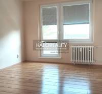 A room with a wooden floor in a 4-room apartment, equipped with a radiator and windows with blinds.