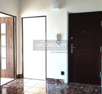 The entrance hall of a 4-room apartment with dark tiles and white walls.