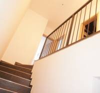 A staircase with a metal railing in a family house, simple interior design.
