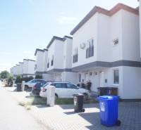 Row houses on Platanova Street in Miloslavov with parking spaces in front of the houses.