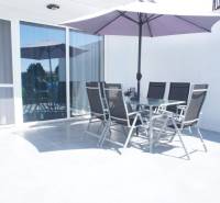 A terrace with seating and a parasol in a family house on Platanova Street in Miloslavov.