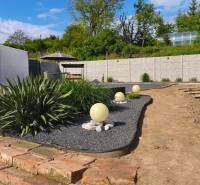 Garden near recreational plots in Záhorce at Selešťany with ornamental plants and flower beds.