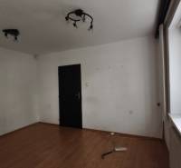 Empty room with white walls, laminate flooring, and a window in the offices.