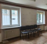 Offices with chairs, windows, curtains, and wooden flooring.
