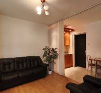 Living room with a black leather couch and a kitchen area, Offices.