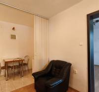 The interior of an office with a sofa and a table in a bright space.
