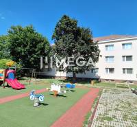Playground near a 2-room apartment in Humenné on Nemocničná 21 with climbing frames and a slide.