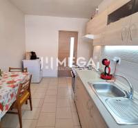 Kitchen in a 2-room apartment with a kitchen unit and a dining table.