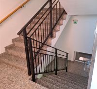 Staircase with metal railing in the building on Lesná Street in Miloslavov.