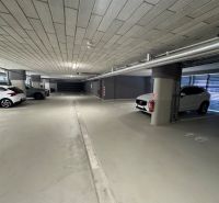 Underground garage with multiple parking spaces and parked cars in Košice.