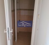 A bathroom in a 3-room apartment with tiles and wall tiles featuring a subtle pattern.
