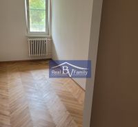 A room with a wooden floor and a radiator in a 3-room apartment.