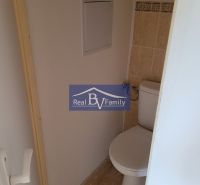 Toilet in a 3-room apartment, light-colored tiles and wall tiles.