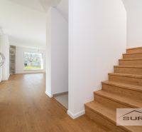 Staircase and room with a large window, wooden decor flooring in a family house.