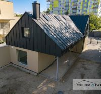 A family house on Železničná Street in Bratislava - Ružinov with a metal roof and a yard.