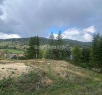 A view of residential plots in Kremnické Bane surrounded by nature and hills.