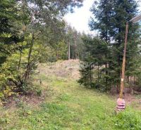 A forest plot in Kremnické Bane ideal for living, surrounded by greenery and trees.