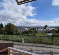View from a family house in Ličartovce with nature and a road.