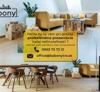 Living space with a wooden table on Okružná Street, suitable for residential land.