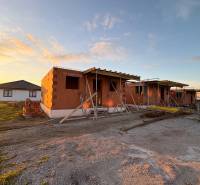 Construction of houses in Ľubotice at sunset, cladding with brick blocks.