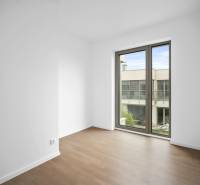 A room with a wooden floor decor and a large window in a 4-room apartment.