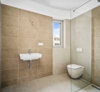 Bathroom with a shower, toilet, and sink in a 4-room apartment.
