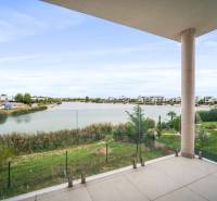 A balcony with a view of the lake and modern residential buildings in Kittsee, 4-room apartment.